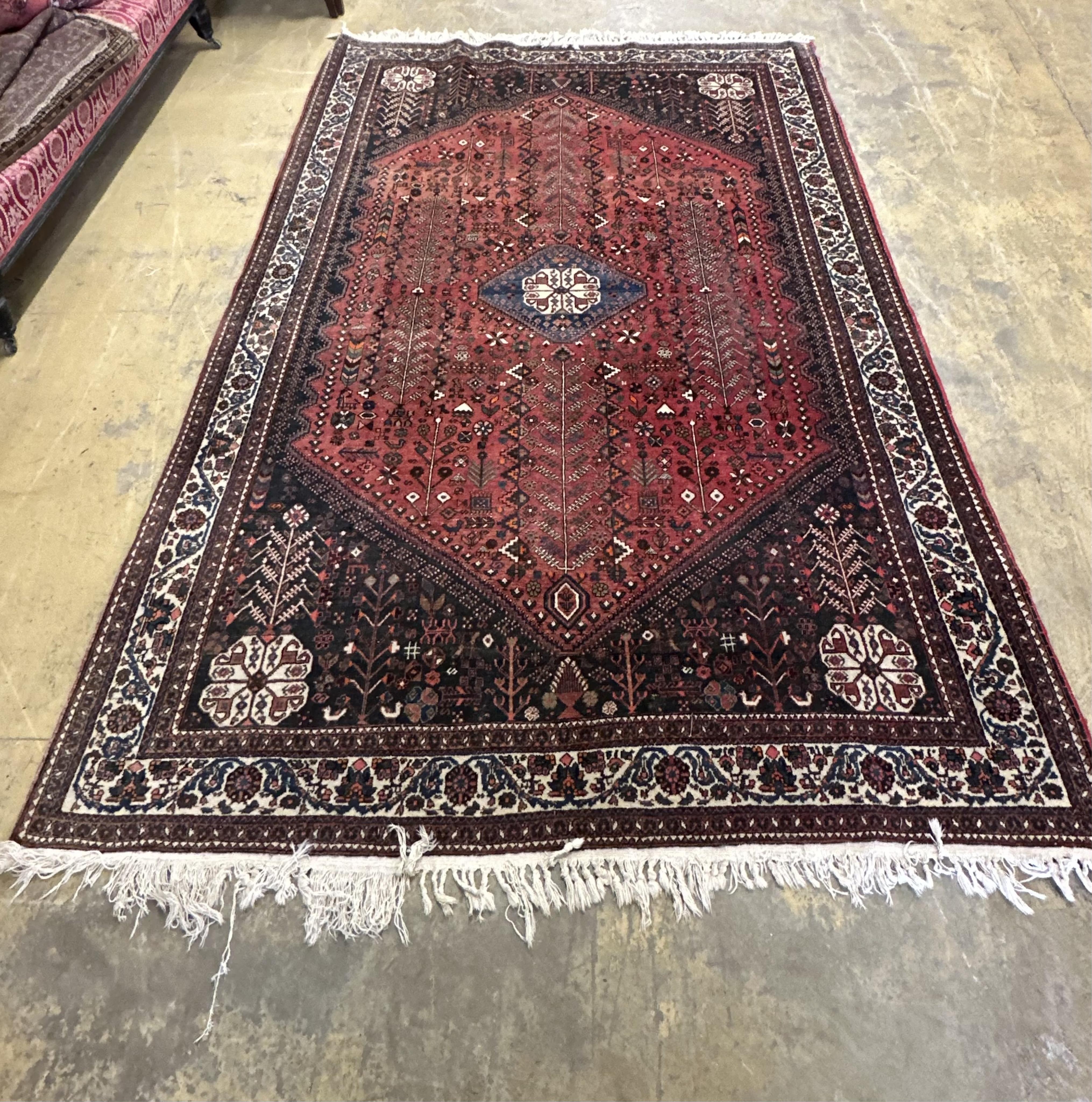 A Qashqai red ground carpet, 300 x 195cm. Condition - fair